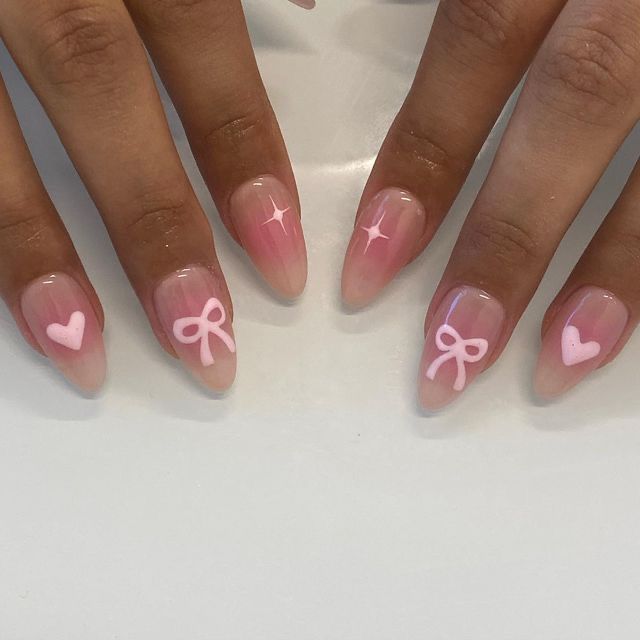 Charming Soft Pink Gradient Nail Design with Bows, Hearts, and Sparkling Stars