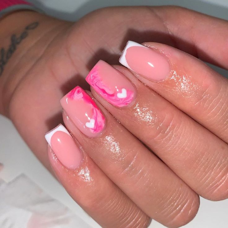 Elegant Soft Pink and White Nail Design with Marbled French Tips for a Playful Touch.