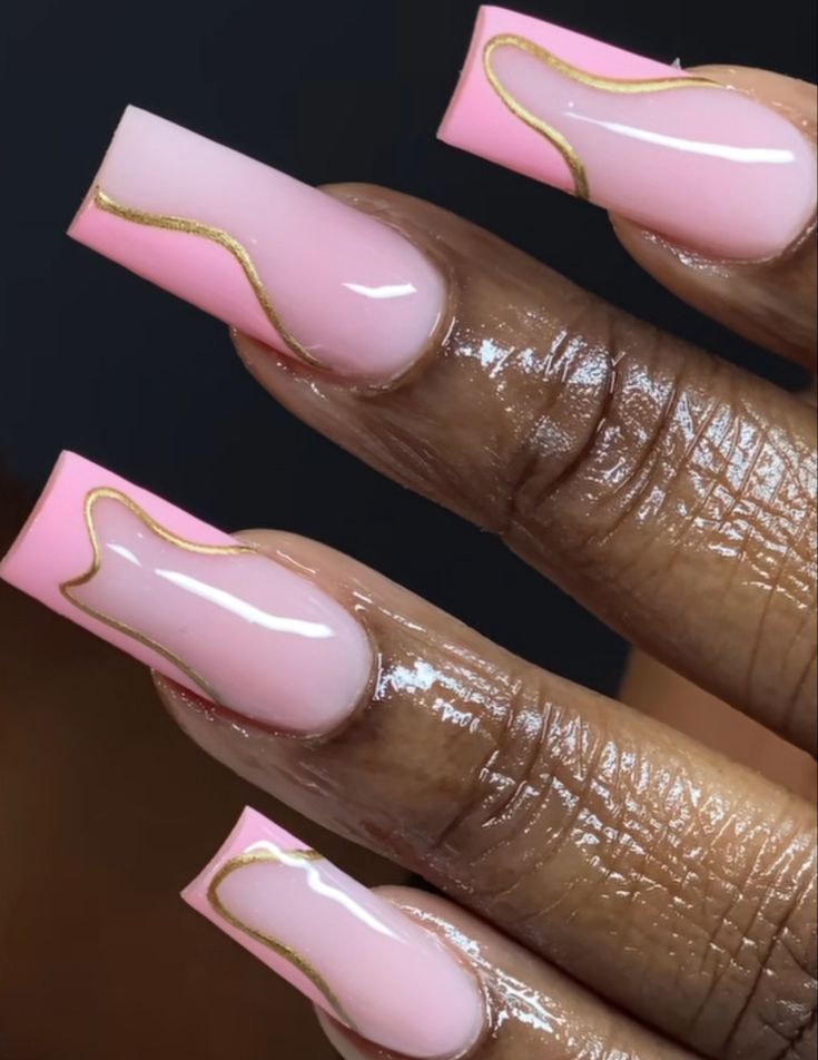 Chic Soft Pink Nail Design with Glossy Accents and Elegant Gold Outlines.