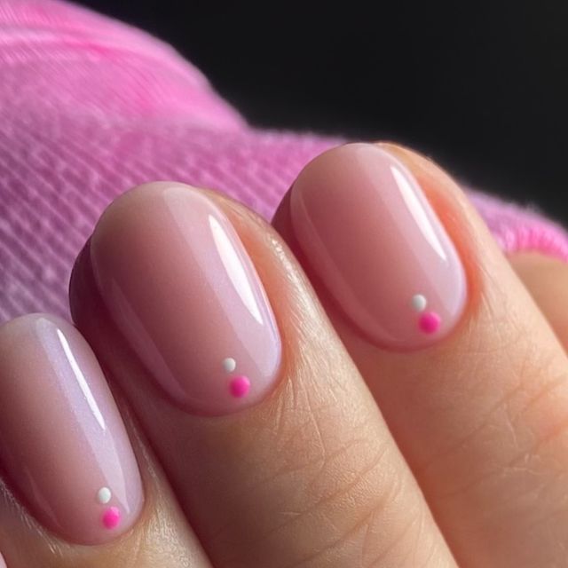 Charming Minimalist Soft Pink Nail Design with Playful Accents.