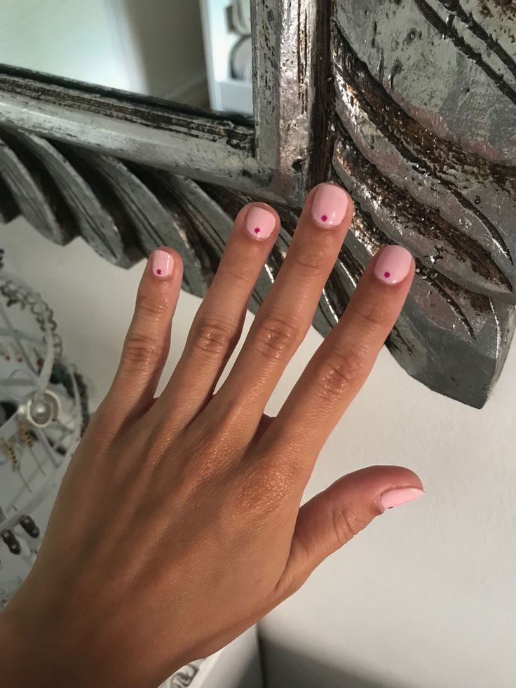 Charming Soft Pink Nails with Playful Red Dot Accents