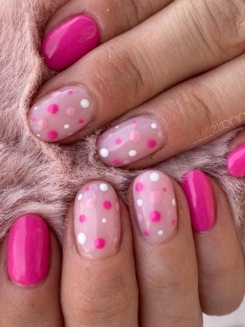 Cheerful Vibrant Pink Nail Design with Whimsical Polka Dots