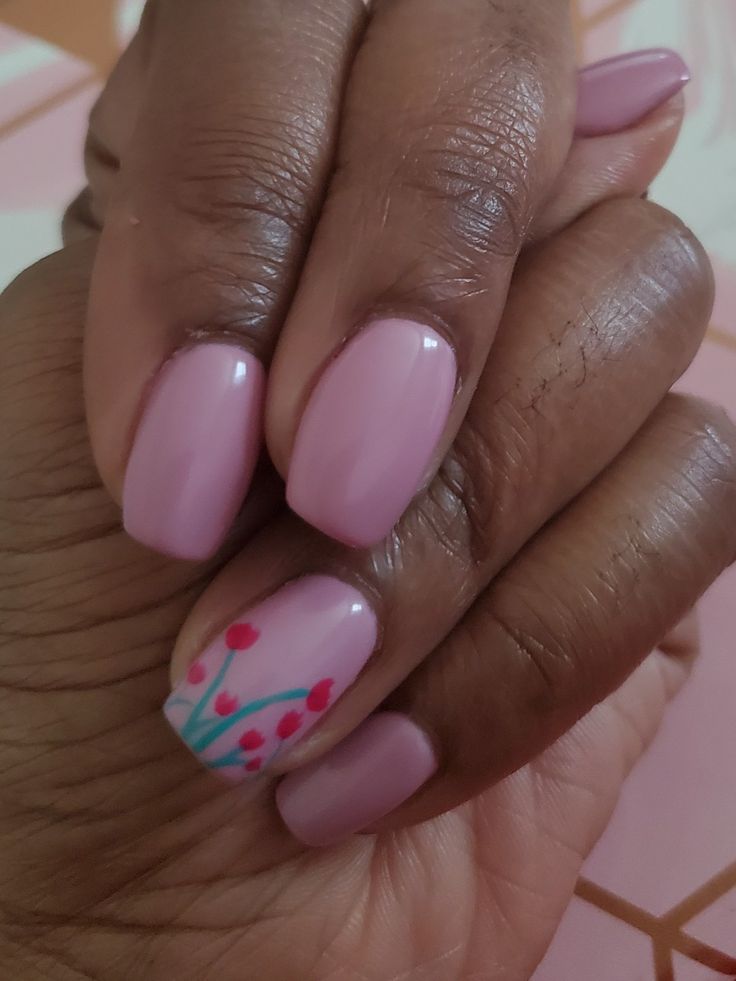 Elegant Soft Pink Nail Design with Floral Accents.