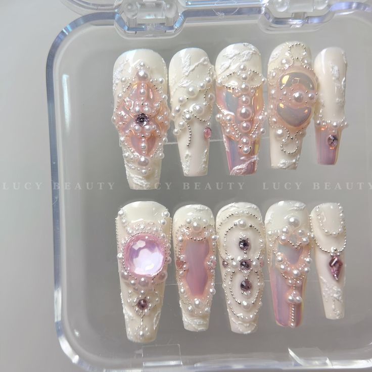 Luxurious Elegant Nail Design with Glossy White Base and Intricate Gem Embellishments.