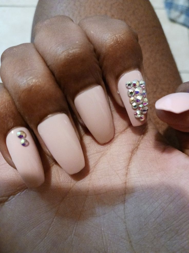 Elegant Nude Nail Design with Sparkling Rhinestone Accents.