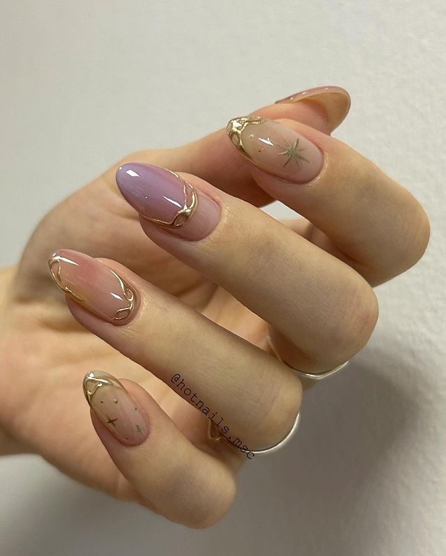 Sophisticated Almond-Shaped Nail Design with Pink and Lavender Hues, Gold Accents, and Star Motifs.