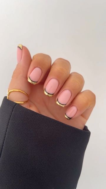 Sophisticated Soft Pink Nail Design with Sleek Black and Gold Tips