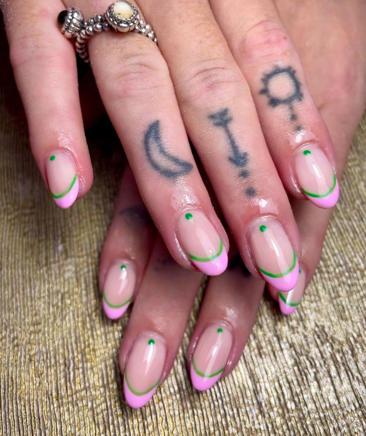 Vibrant Pink Tip Nail Design with Green Accents for a Playful Look.