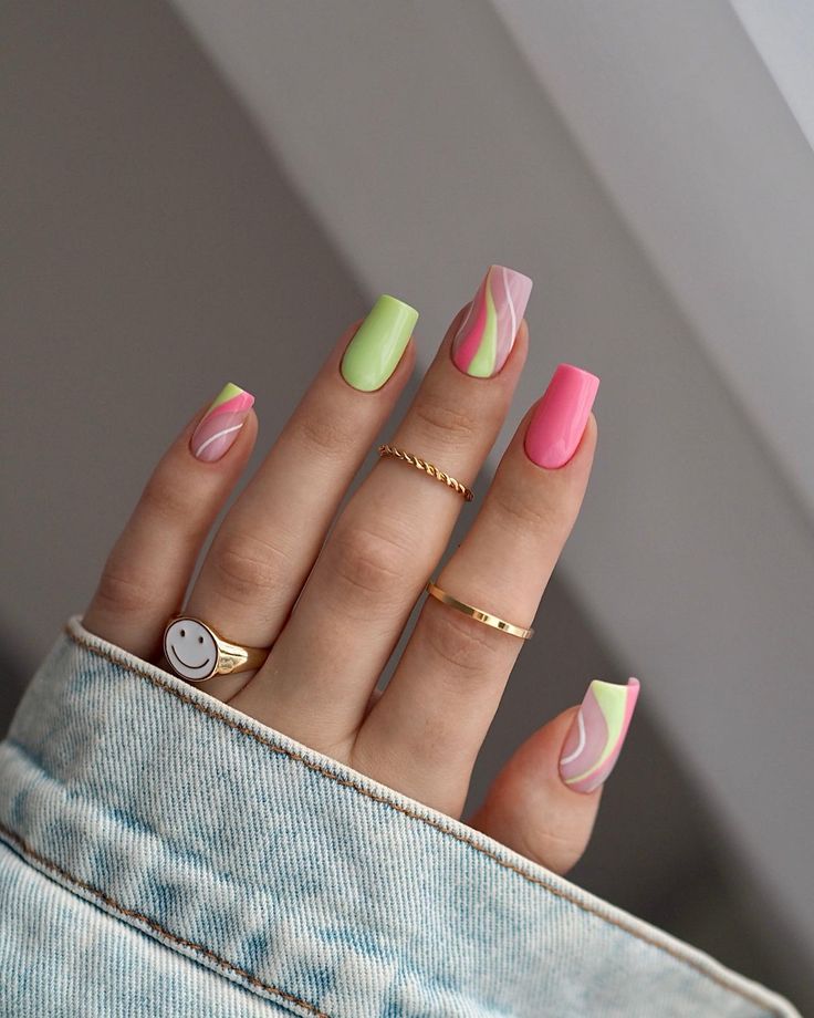 Playful Pastel Nail Design with Wavy Patterns and Gold Accents for Trendy Outings.