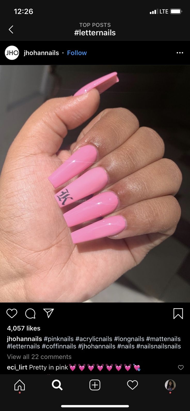 Chic Glossy Long Pink Acrylic Coffin Nails with Personalized Letter Accent.