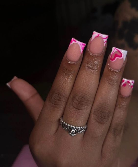 Chic Elegant Nail Design: Soft Pink and White with Vibrant Pink Accents and Heart Patterns.