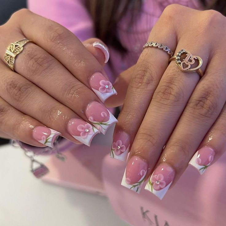 Elegant Floral Nail Design with Soft Pink Base and Hand-Painted Flowers.