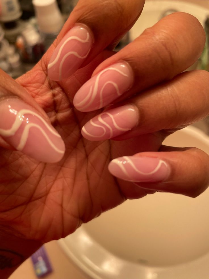 Sophisticated Soft Pink Nail Design with Delicate White Waves