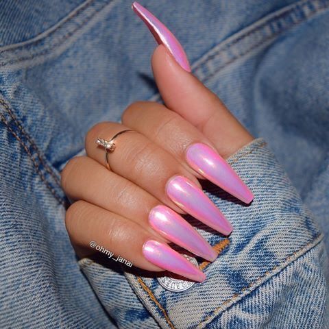 Chic Iridescent Long Stiletto Nails in Soft Pink Against a Denim Backdrop.