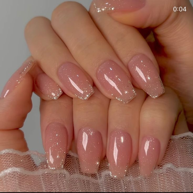 Elegant Ombre Nude Nails with Sparkly Tips for a Chic Look.