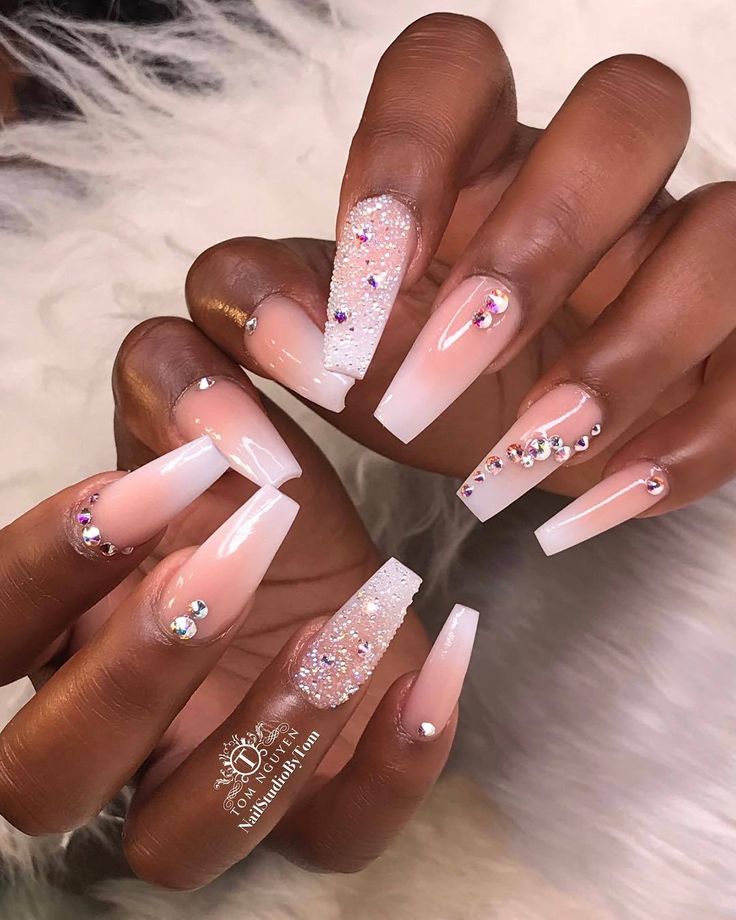 Stunning Glossy Nude and White Tip Nail Design with Glitter and Jewels for a Glamorous Elegance.