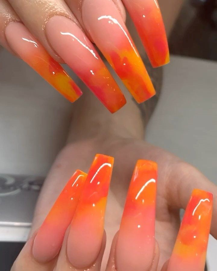 Vibrant Ombre Nail Design: Radiant Orange and Pink Gradients for a Summer Look.