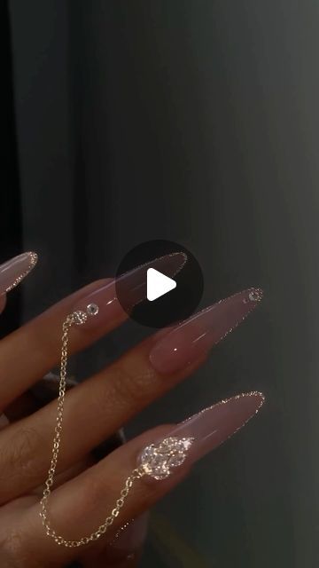 Chic Stiletto Nail Design with Gemstones and Gold Chains for Elegant Looks.