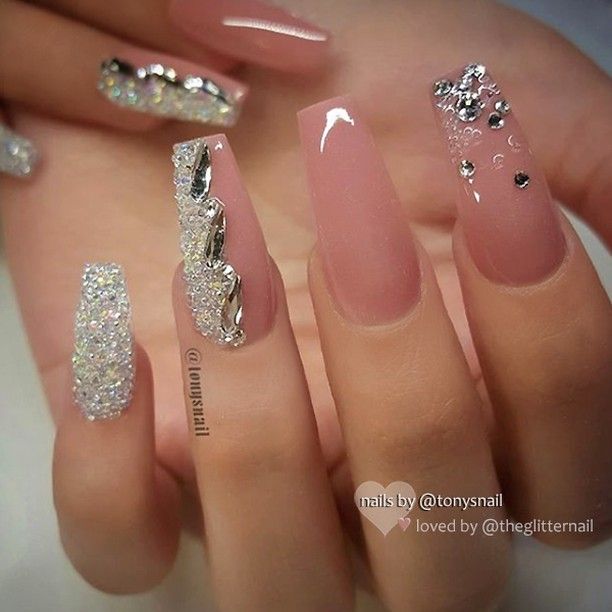 Elegant Nude Nail Design with Glamorous Silver Accents and Rhinestones.