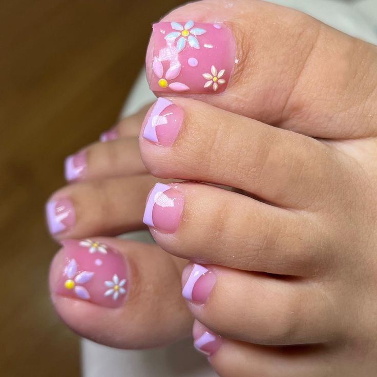 Playful Floral Nail Design: Soft Pink Base with White and Yellow Flowers for a Summery Pedicure.