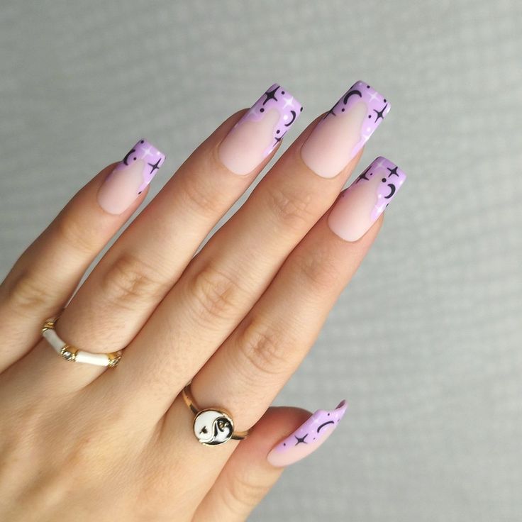 Playful Pink and Lavender Nail Art with Whimsical Black Patterns.