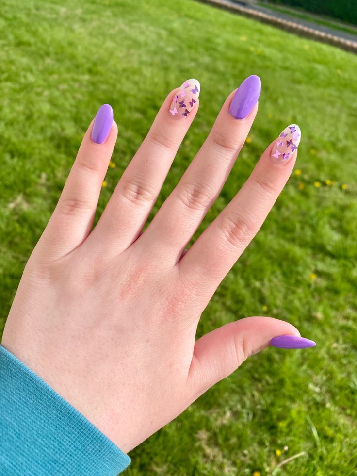 Playful Purple-Themed Nail Design with Vibrant Polish and Star Tips