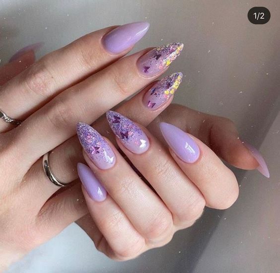 Elegant Lavender Almond Nails with Glitter Accents and Gradient Flair.