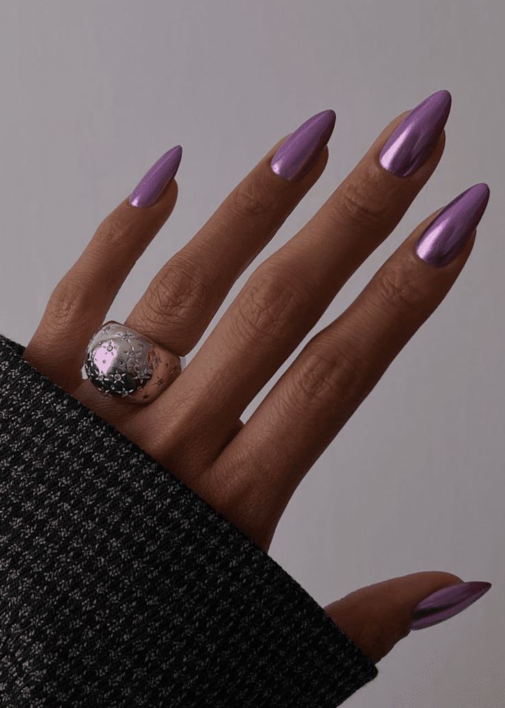 Elegant Glossy Purple Long Nails with Striking Reflections and Bold Accessories.