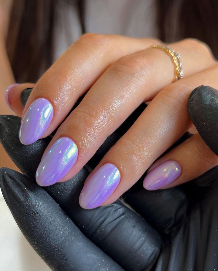 Chic Iridescent Lavender Almond Nails with Glamorous Finish and Gold Accents.