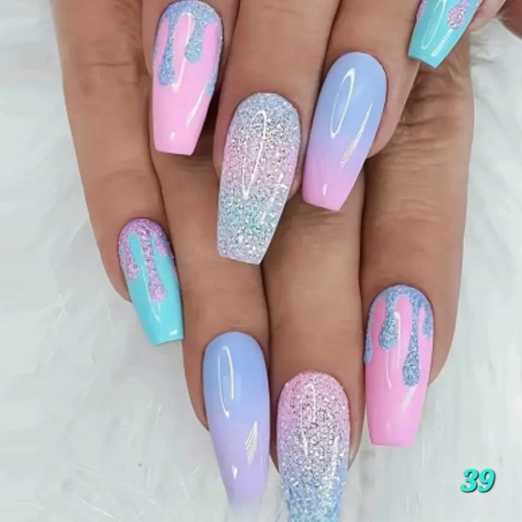 Chic Pastel Pink and Blue Nail Design with Glitter and Playful Dripping Details.