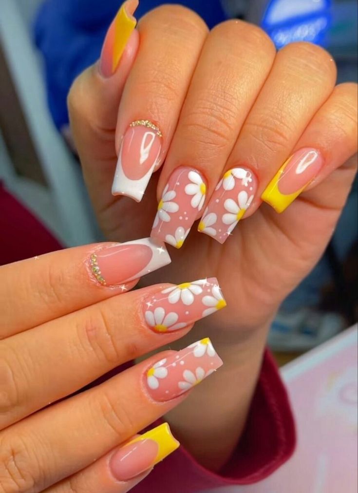 Chic Nail Design: Soft Pink and Bright Yellow with Whimsical Floral Accents and Elegant Gold Details.