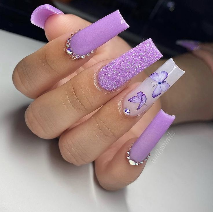 Elegant Purple Nail Design with Glossy, Glitter Finishes and Sparkling Butterfly Accents.