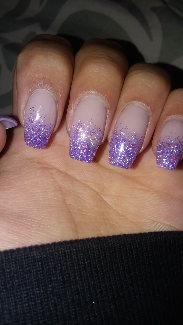 Elegant Glitter Ombre Nails: Soft Nude to Vibrant Purple with Sparkling Tips.