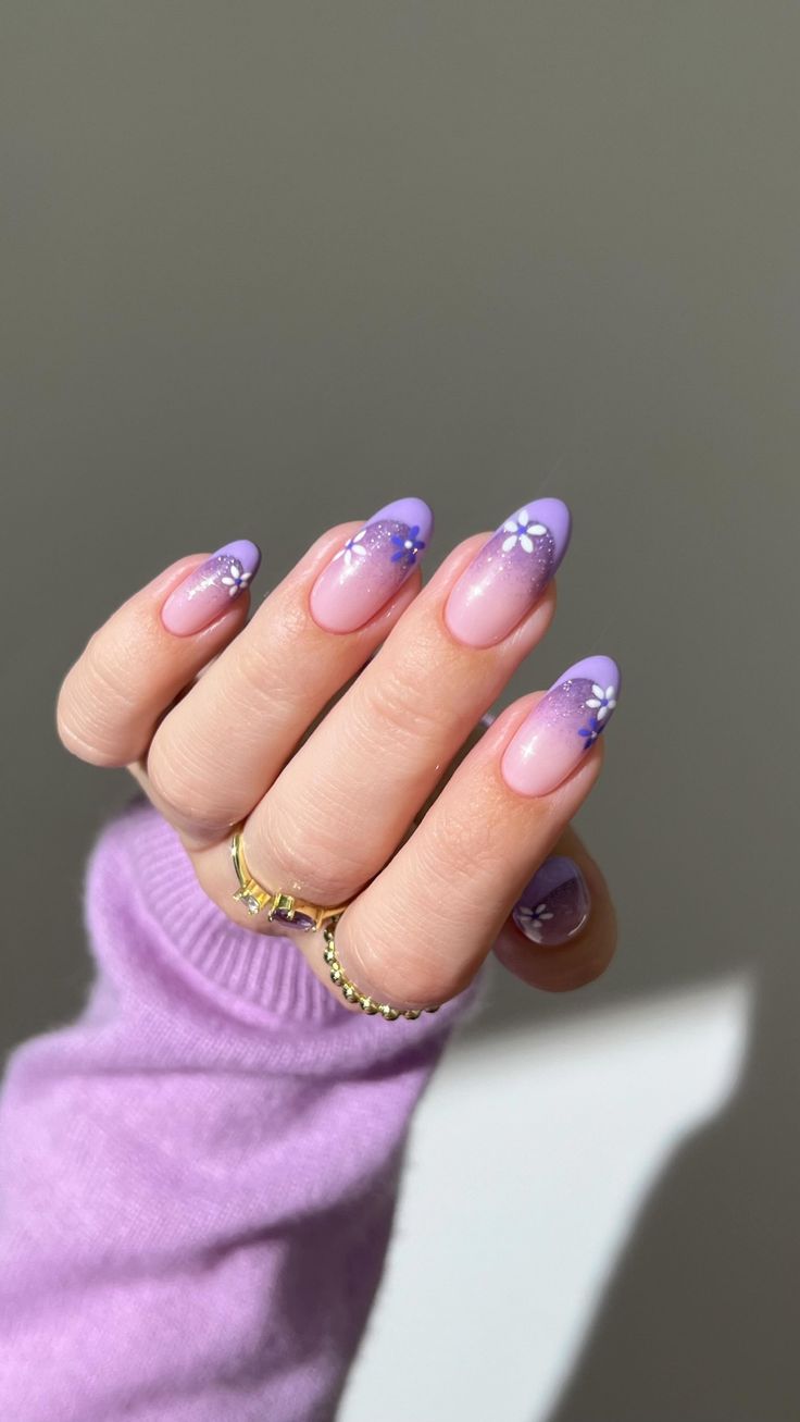 Whimsical Lilac Ombre Nails with Floral Accents for a Refreshing Spring Look.