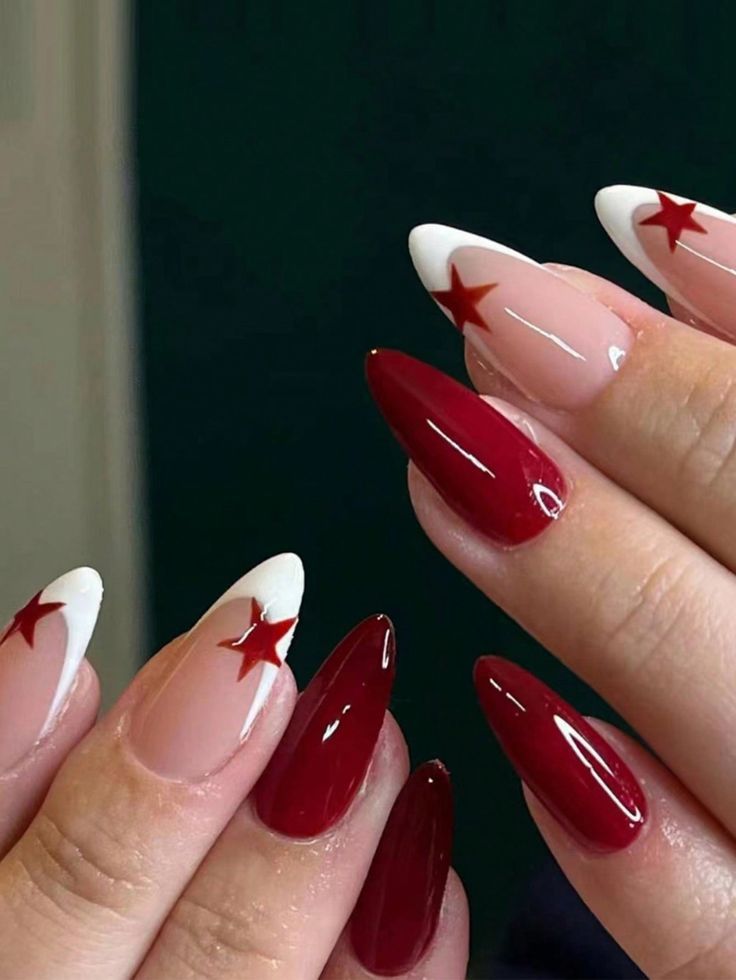 Chic Nail Design: Deep Red and Nude with White Tips and Petite Red Stars.