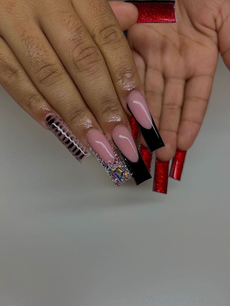 Bold Mixed-Texture Long Nails with Glossy Black, Nude, and Vibrant Red Finishes, Featuring Rhinestone Accents.