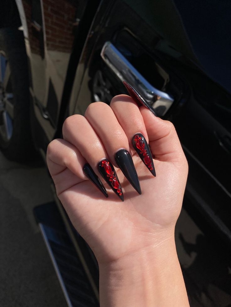 Dramatic Long Pointed Nail Design in Glossy Black with Bold Red Accents