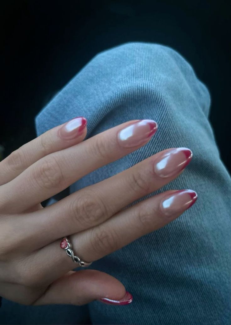 Chic Ombre Almond Nails: A Glossy Blend of Nude and Pink with Elegant Accents.