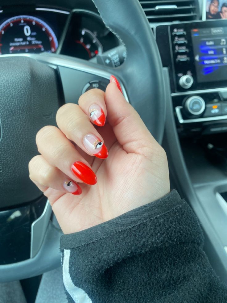 Vibrant Red Nail Design with Playful Accents and Eye-Catching Patterns