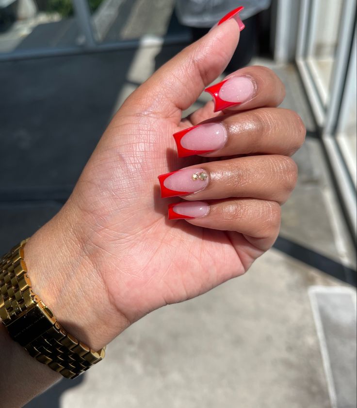 Elegant Red-Tipped Ombre Nails: A Chic Blend of Boldness and Sophistication.