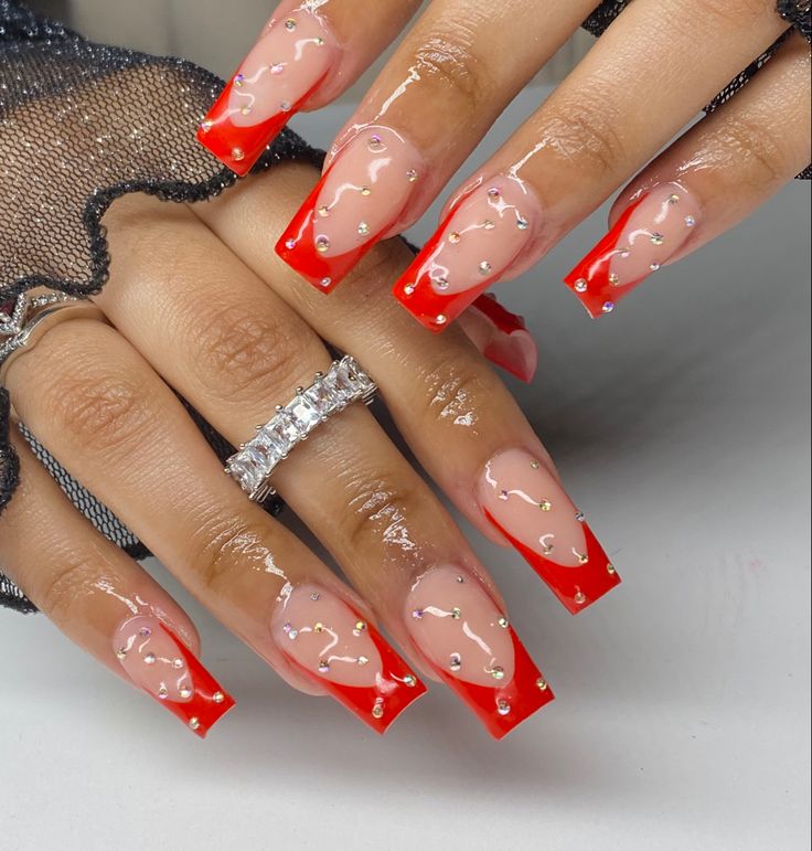 Chic Vibrant Red French Tips with Silver Studs for a Polished Statement Manicure.