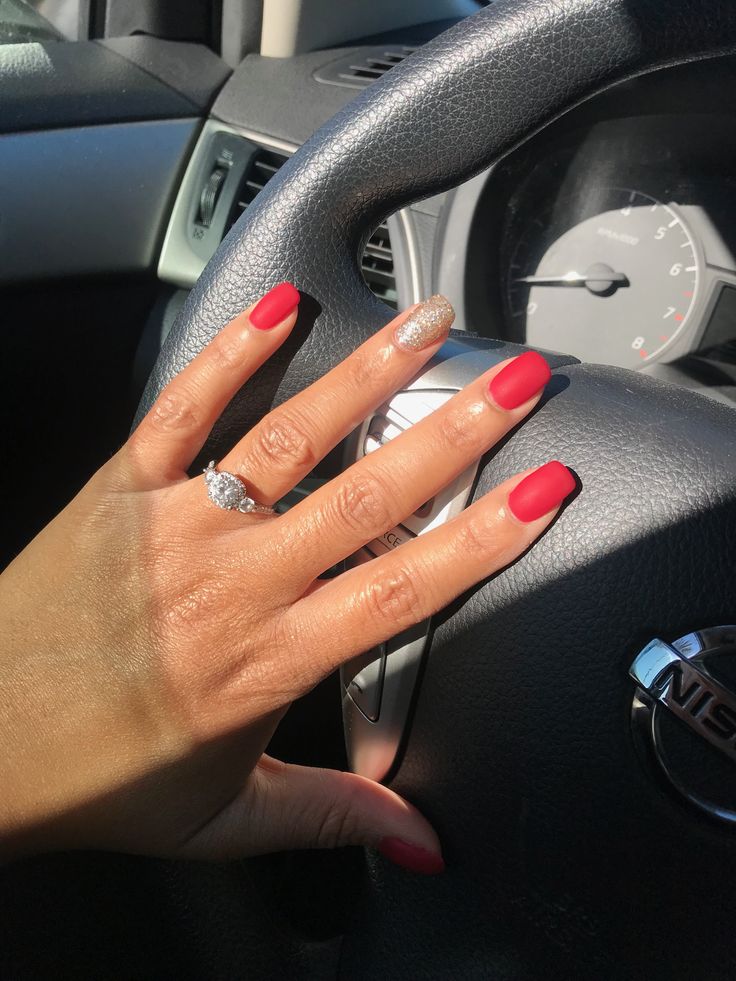 Chic Red Manicure with Glamorous Gold Accent for a Bold Look.