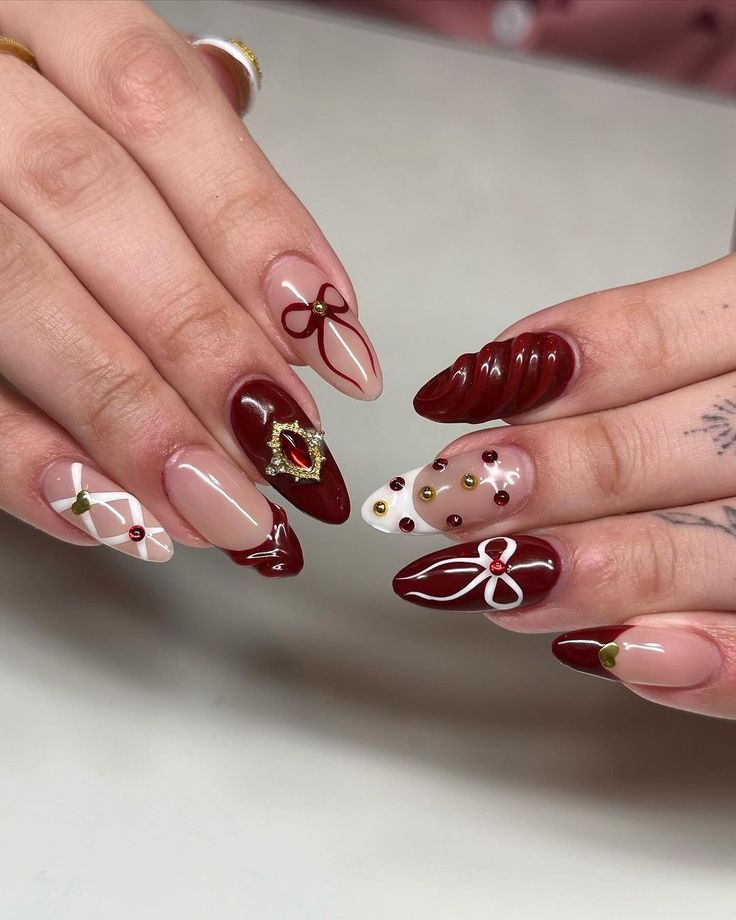 Sophisticated Elegant Nail Design: Deep Burgundy, Soft Nude, and Intricate Gold Accents for Special Occasions.