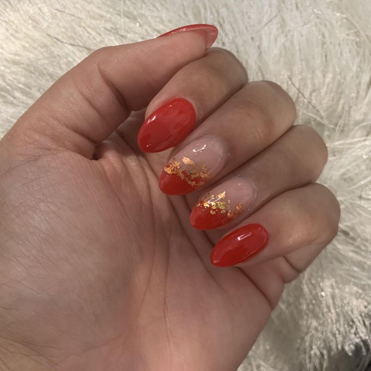 Chic Red and Nude Nail Design with Glossy Tips and Gold Flakes