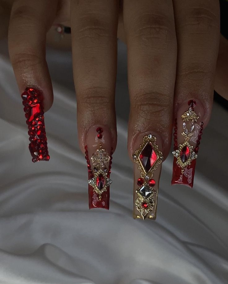 Elegant Red Nail Design with Sparkling Embellishments for Special Occasions.