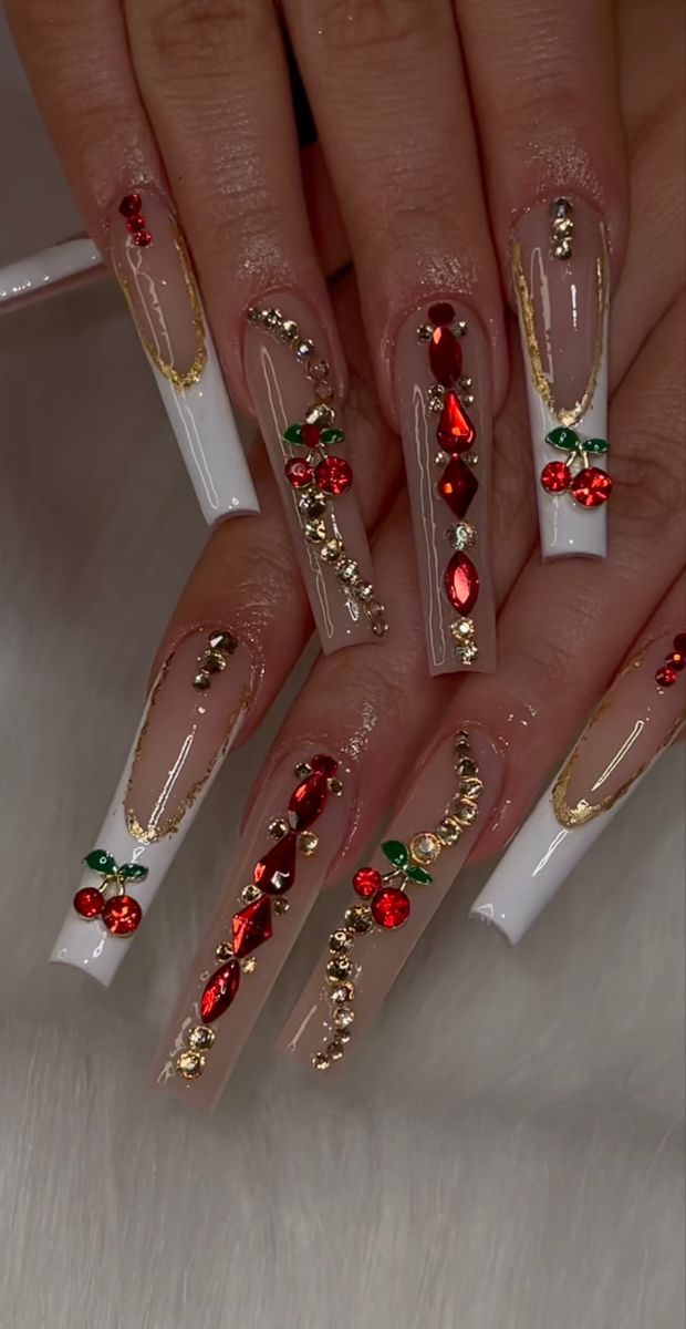 Elegant and Playful Nail Design with Cherry Motifs and Glamorous Gold Detailing.