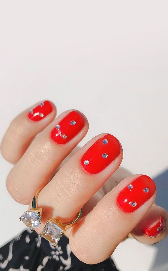 Bold and Glamorous Vibrant Red Nails with Sparkling Rhinestones.