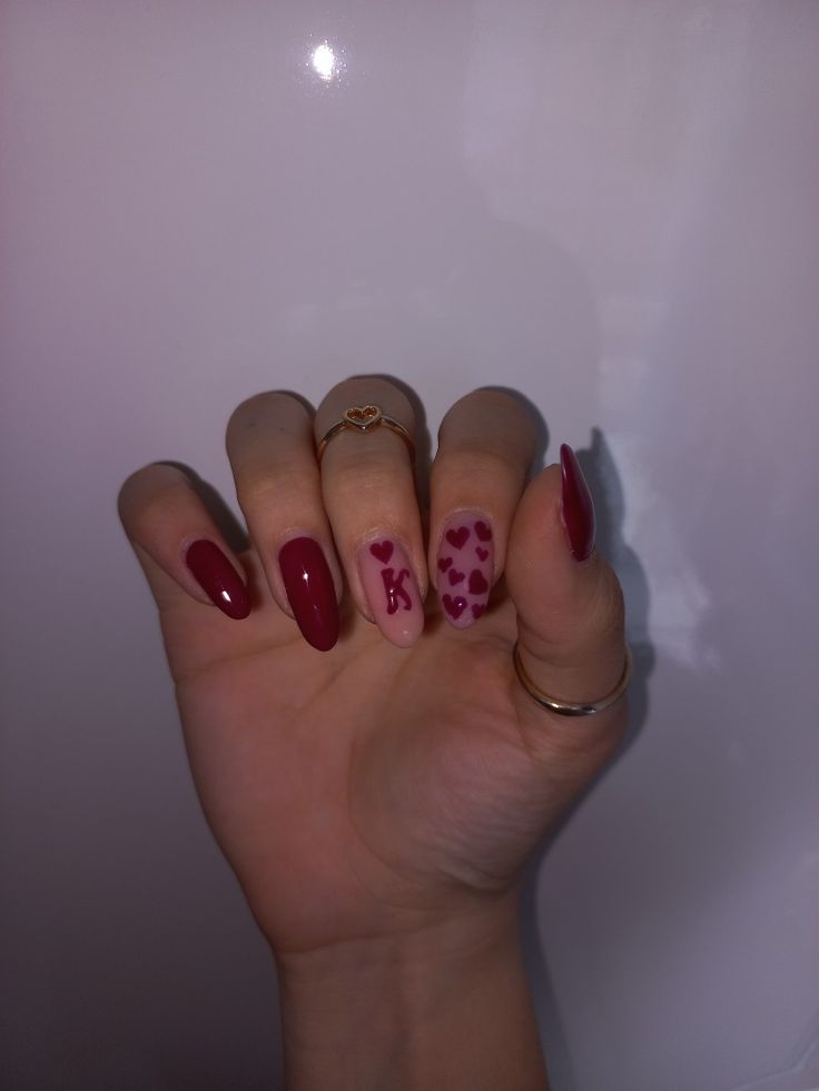 Charming Burgundy Nail Design with Heart Accents Perfect for All Occasions.