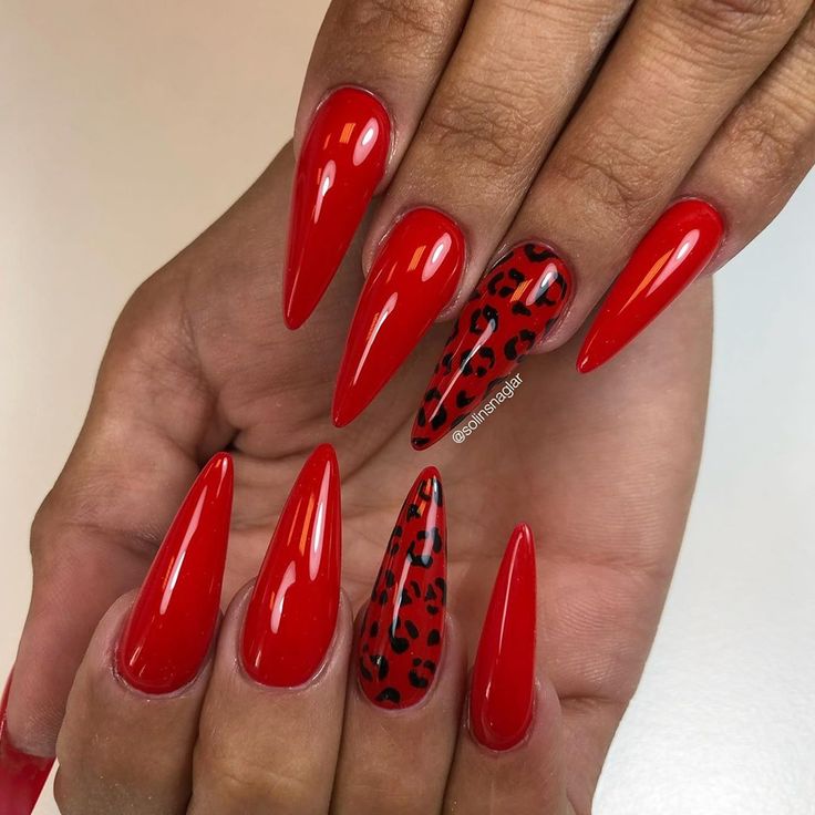 Bold and Elegant Vibrant Red Stiletto Nails with Striking Leopard Print Accent.