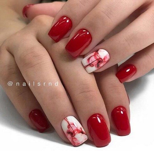 Elegant Red and White Nail Design with Glossy Finish and Marbled Accents.